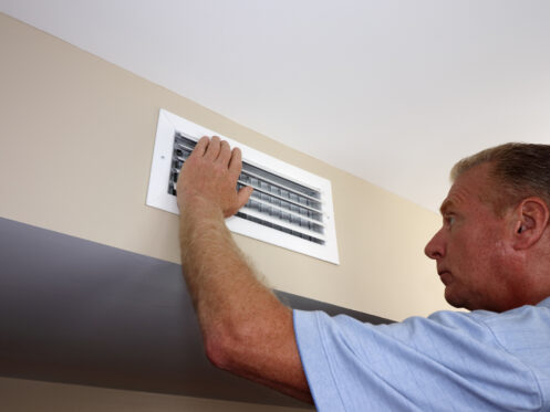Technician adjusting damper