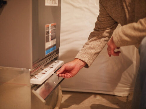 A man changing the furnace filter in Palm Springs