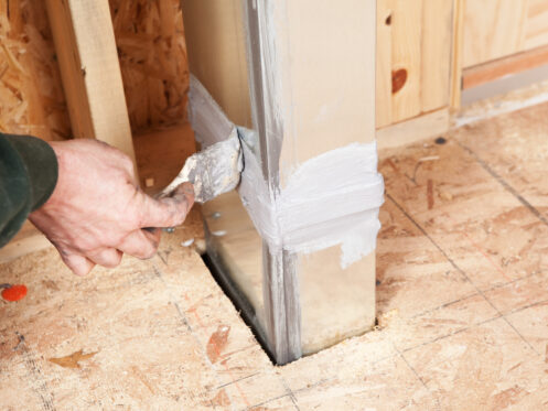 A man sealing an air duct in Palm Springs